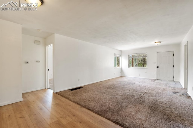 unfurnished living room featuring light hardwood / wood-style flooring