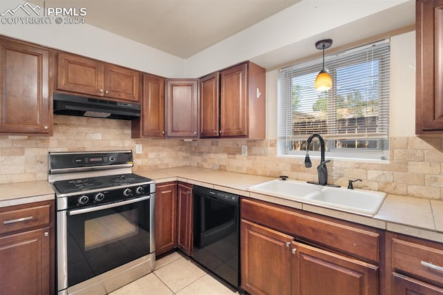 kitchen featuring dishwashing machine, tasteful backsplash, exhaust hood, stove, and sink