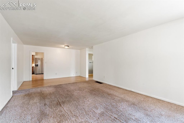 spare room featuring light colored carpet