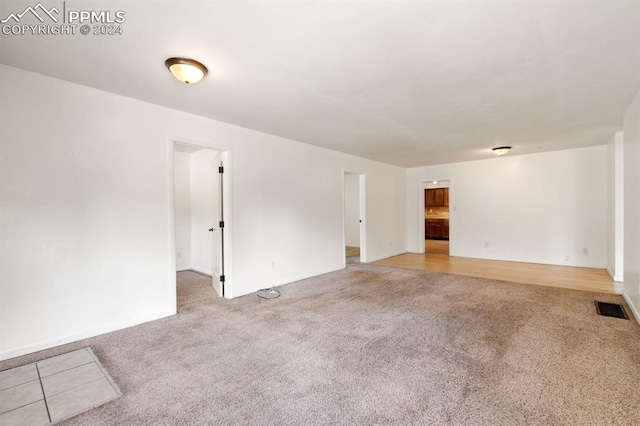 empty room featuring light colored carpet