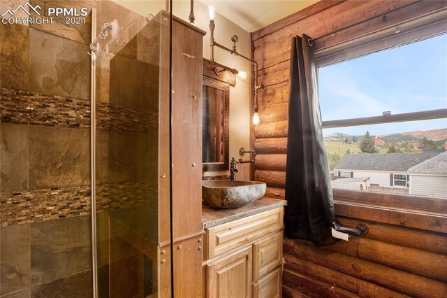 bathroom with log walls and vanity