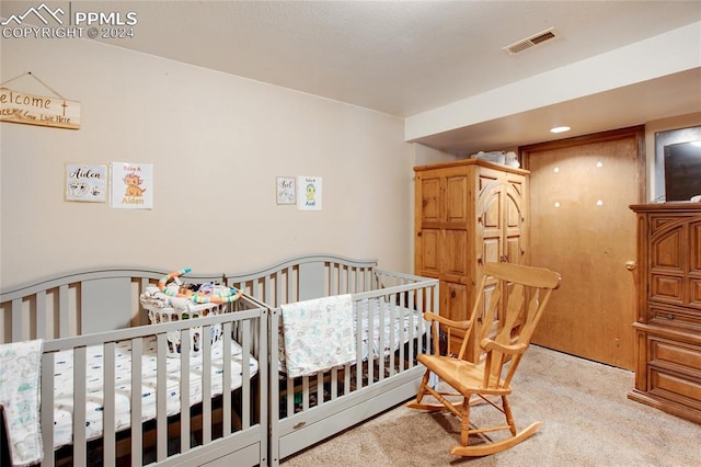 carpeted bedroom with a crib