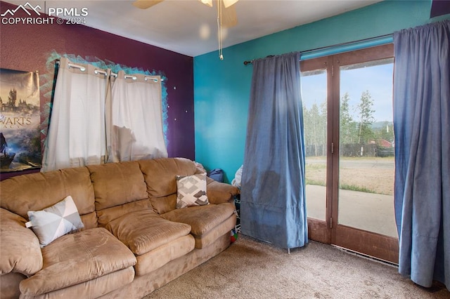 carpeted living room featuring ceiling fan