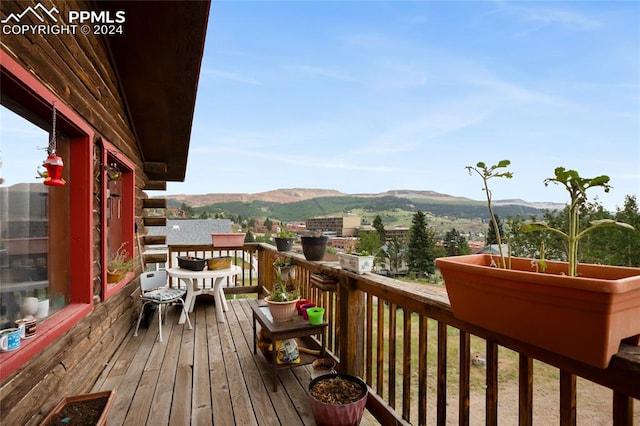 wooden deck with a mountain view