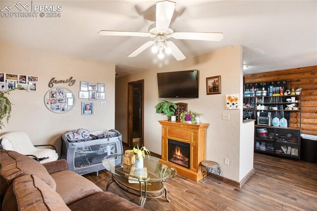 living room featuring ceiling fan and hardwood / wood-style flooring