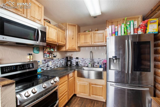 kitchen featuring dark wood-type flooring, stainless steel appliances, sink, and light brown cabinetry