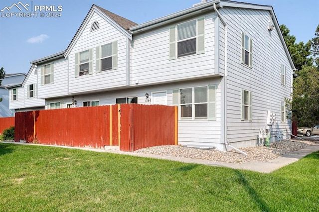 exterior space featuring a lawn and fence