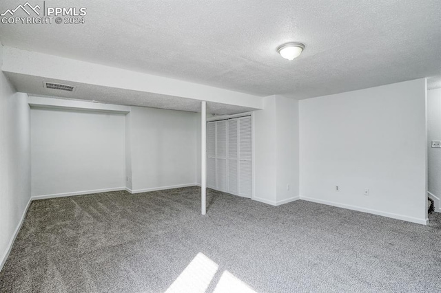 unfurnished bedroom featuring carpet floors, a closet, visible vents, a textured ceiling, and baseboards