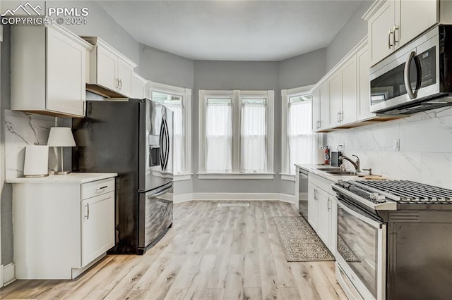 kitchen with white cabinetry, appliances with stainless steel finishes, and sink