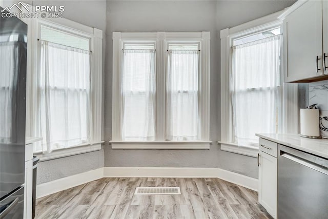 unfurnished dining area with light wood-type flooring