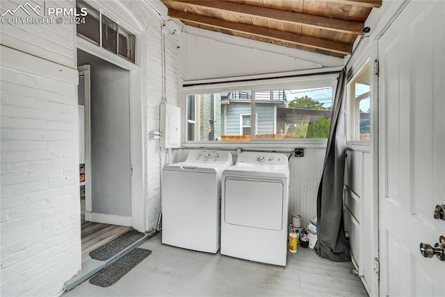 washroom with wood ceiling and washing machine and clothes dryer