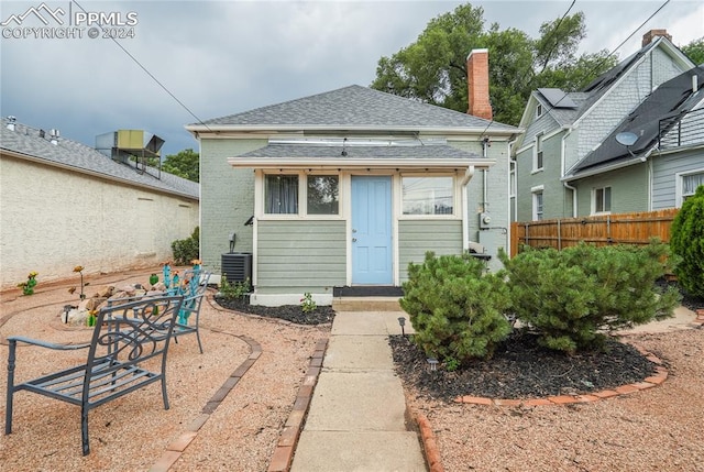 rear view of property featuring central AC unit