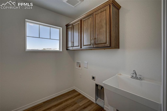 laundry room with cabinets, dark wood-type flooring, sink, washer hookup, and hookup for an electric dryer