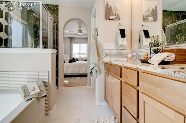 bathroom featuring tile patterned flooring, connected bathroom, vanity, a ceiling fan, and backsplash