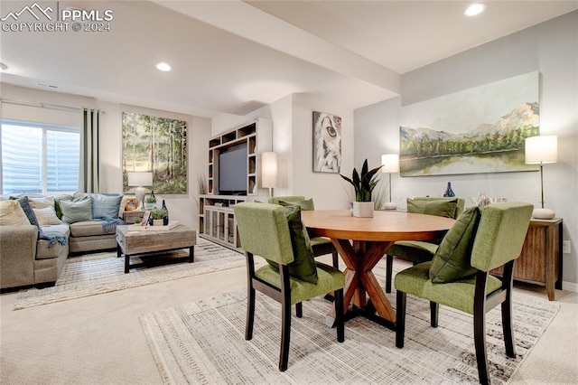 dining room featuring light colored carpet and recessed lighting