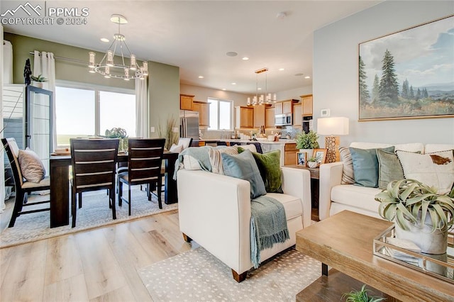 living room featuring light hardwood / wood-style floors and an inviting chandelier