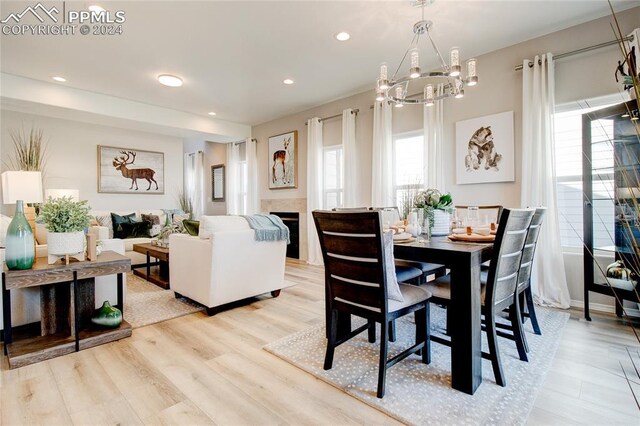 dining room with a notable chandelier and light hardwood / wood-style flooring