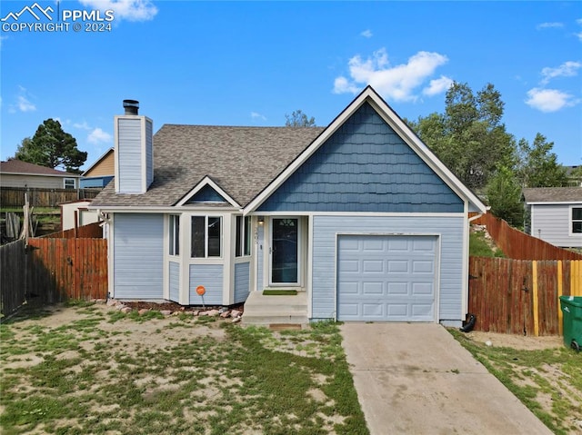 view of front of property with a front lawn and a garage