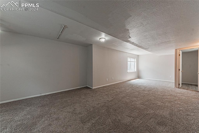 basement with carpet and a textured ceiling