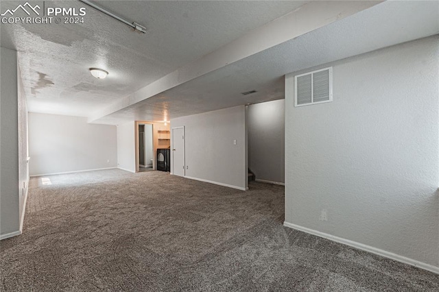 basement with carpet and a textured ceiling