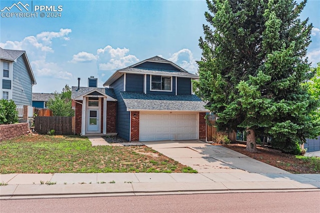 front facade featuring a garage and a front lawn