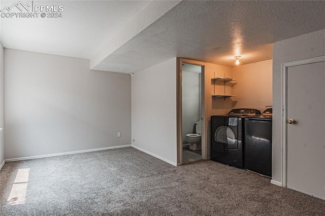 interior space with a textured ceiling, washer and dryer, and carpet