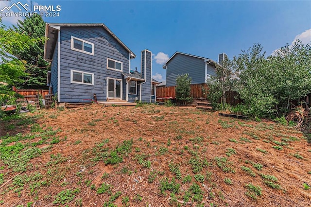 back of property with a wooden deck