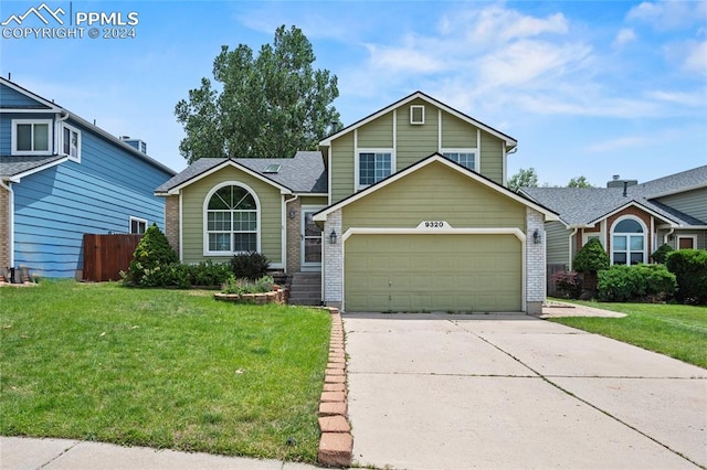 view of front of property with a garage and a front yard