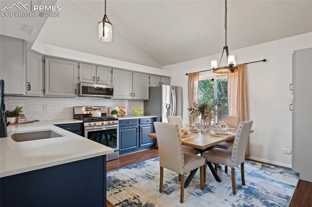 kitchen with stainless steel dishwasher, tasteful backsplash, sink, dark hardwood / wood-style flooring, and blue cabinets