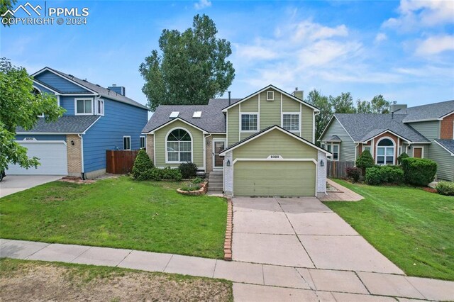 view of front property featuring a garage and a front lawn