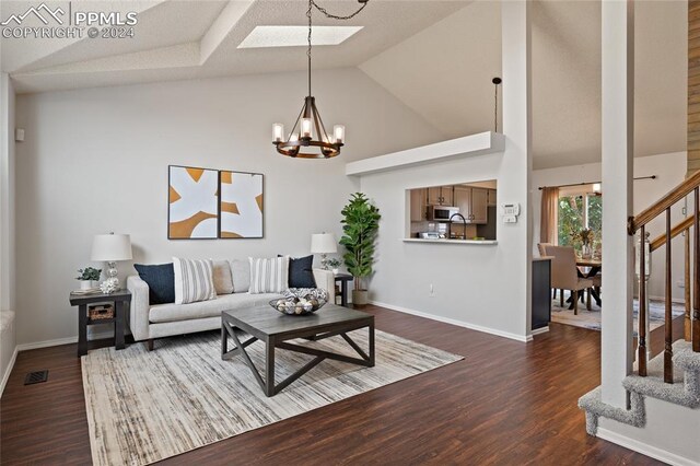 foyer featuring a skylight, dark wood-type flooring, a chandelier, and a textured ceiling