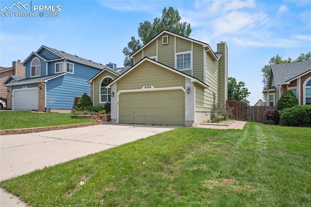 view of property with a garage and a front lawn