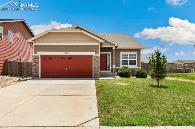 view of front of property with a garage and a front lawn