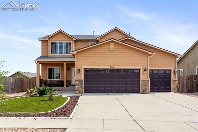7848 Chasewood Loop, Colorado Springs, CO 80908 - craftsman-style house with stone siding, fence, and an attached garage