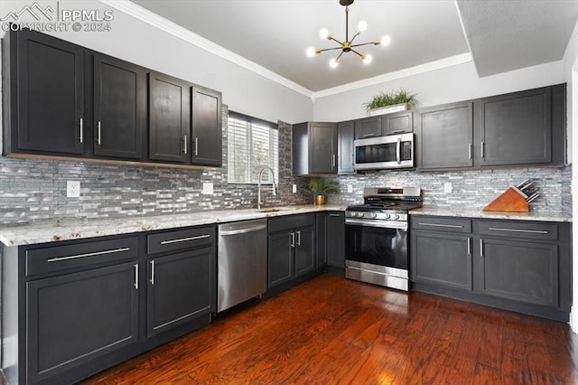 7848 Chasewood Loop, Colorado Springs, CO 80908 - kitchen with an inviting chandelier, light stone counters, appliances with stainless steel finishes, dark wood-style flooring, and a sink