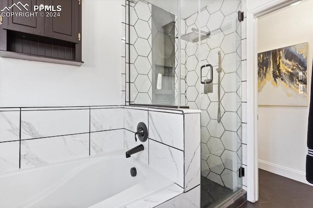 7848 Chasewood Loop, Colorado Springs, CO 80908 - bathroom with a tub to relax in, a stall shower, tile patterned floors, and baseboards