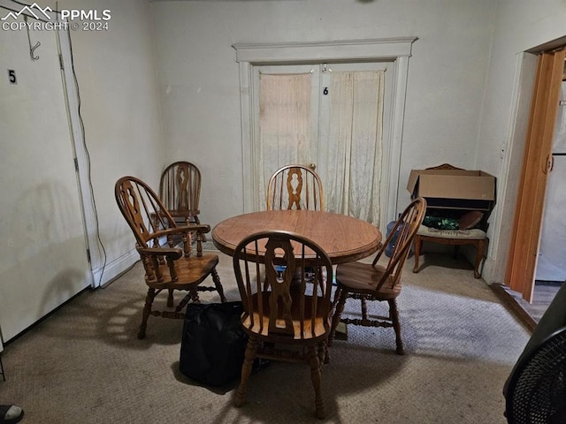 dining room featuring dark colored carpet