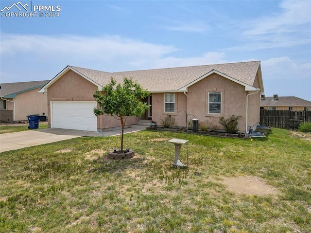 single story home with a garage and a front lawn