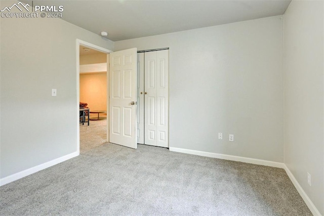 spare room featuring light colored carpet