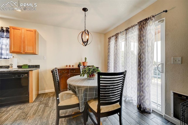 dining area with hardwood / wood-style floors and an inviting chandelier