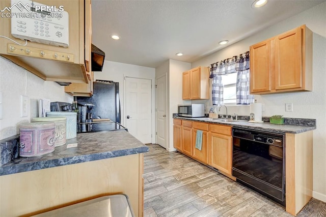 kitchen with stainless steel appliances, light brown cabinetry, sink, and light wood-type flooring