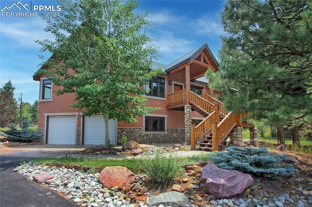 view of front of house with a garage and a balcony