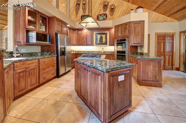 kitchen featuring a center island, hanging light fixtures, vaulted ceiling, wood ceiling, and appliances with stainless steel finishes