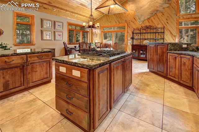 kitchen featuring dark stone counters, decorative light fixtures, wooden ceiling, a chandelier, and stainless steel gas stovetop