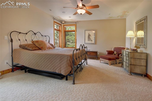 bedroom featuring ceiling fan and light carpet