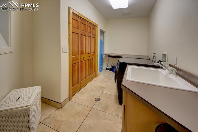 interior space with washer hookup, cabinets, and light tile patterned floors