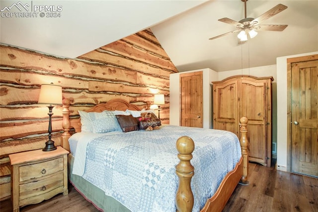 bedroom with vaulted ceiling, dark hardwood / wood-style flooring, and ceiling fan