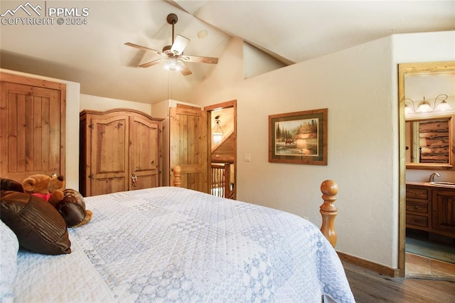 bedroom with ensuite bathroom, sink, ceiling fan, lofted ceiling, and dark hardwood / wood-style flooring