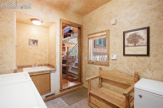 bathroom with washing machine and clothes dryer, tile patterned floors, toilet, and vanity