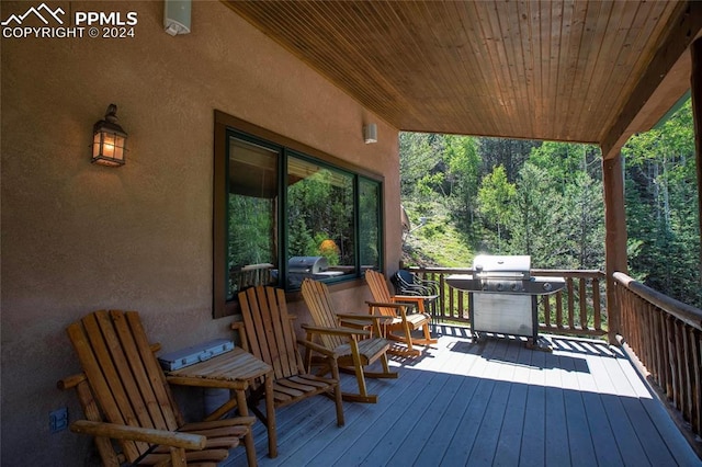 wooden terrace with a grill